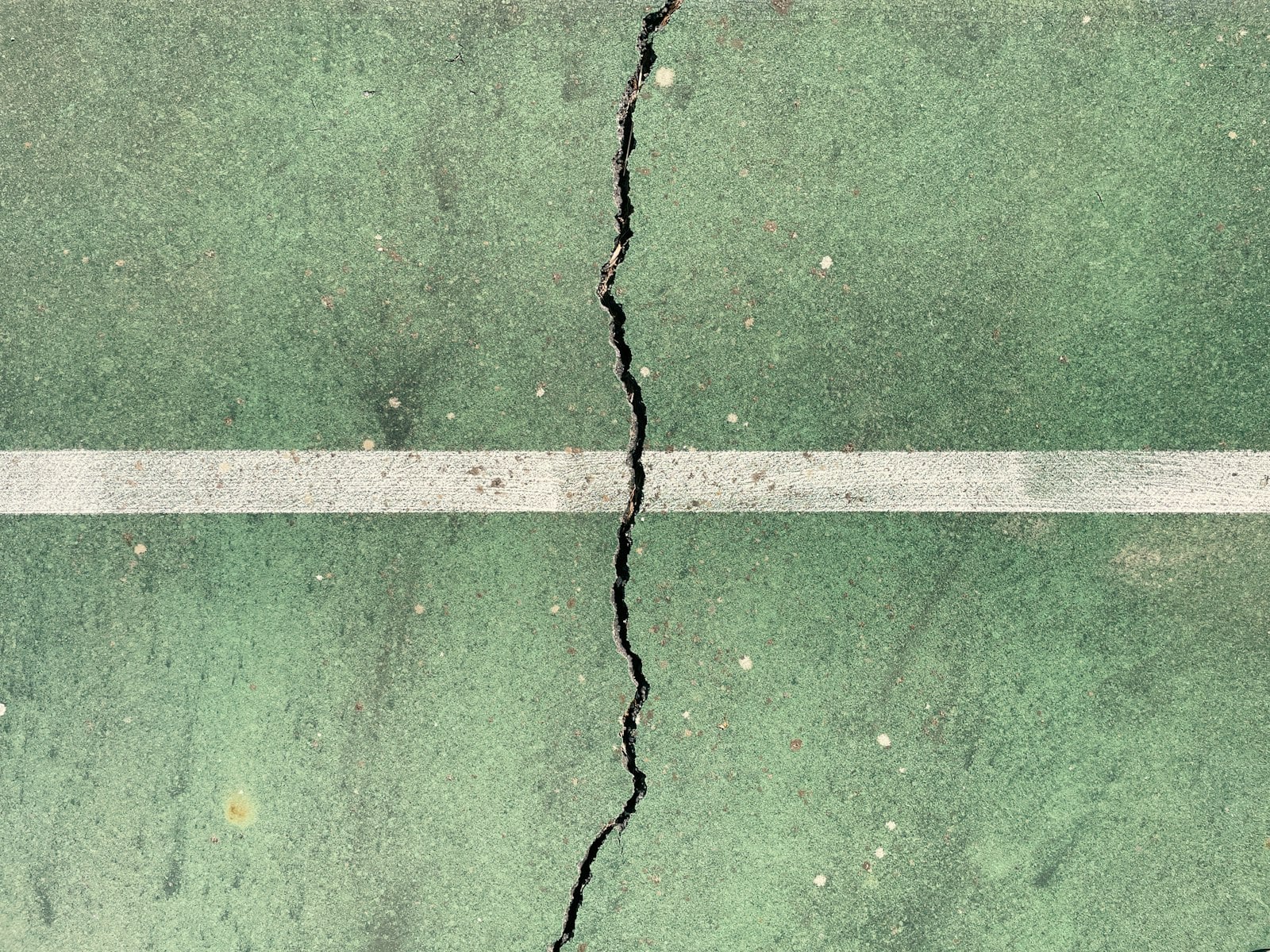 Crack running across a painted concrete slab